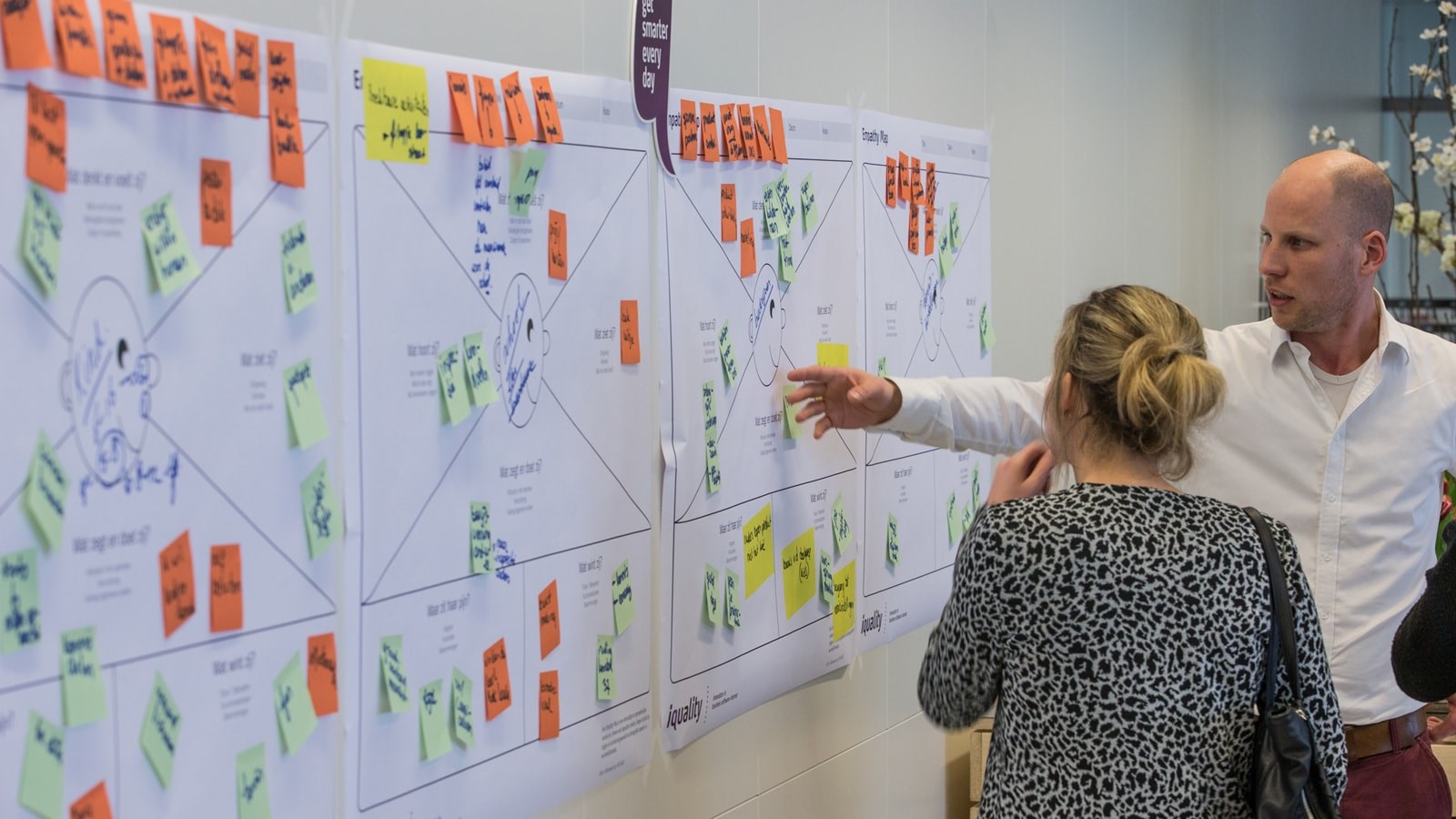 Iquality employee discussing the business model canvas