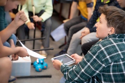 image of colleague coding with children. 